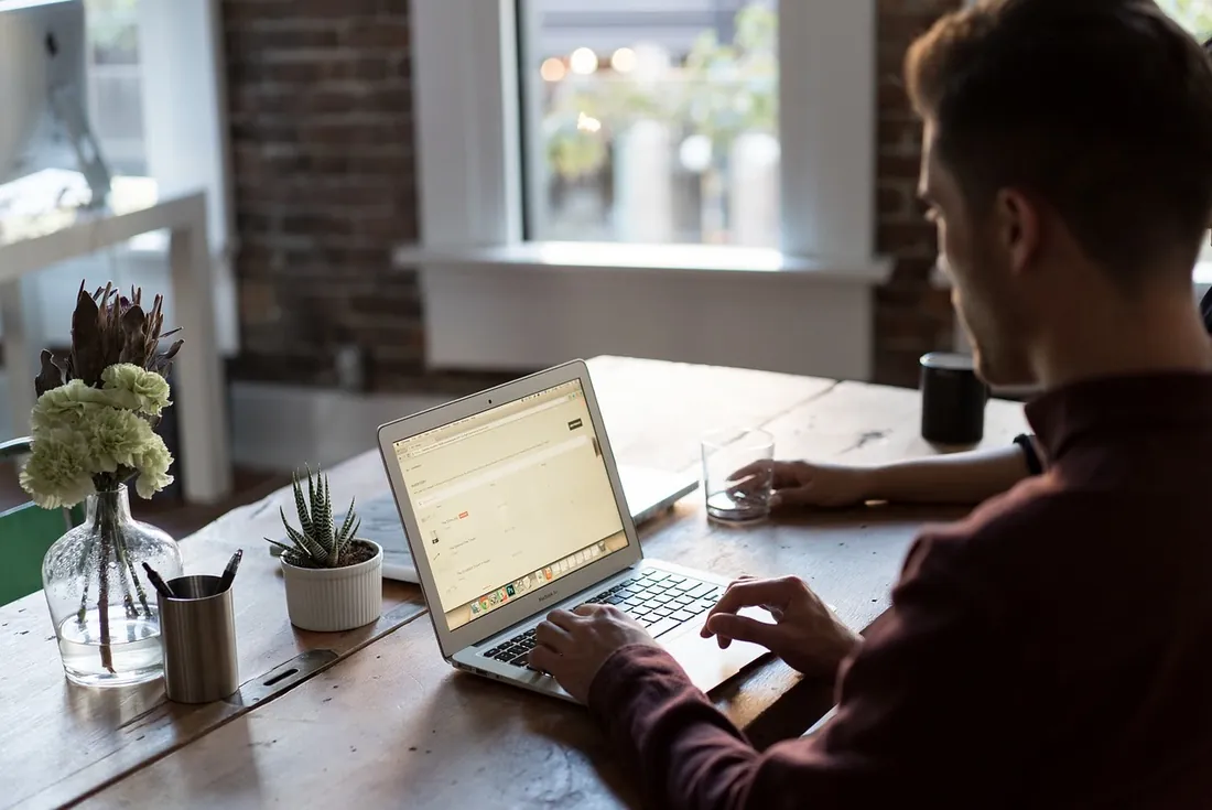 A customer working on a laptop over coffee-shop Wi-Fi
